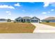 Beautiful single-story home with blue exterior, an attached two-car garage, and a well-maintained lawn at 4881 Se 91St Pl, Ocala, FL 34480