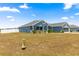 Single-story home featuring a blue exterior, well-kept landscaping, and an attached two-car garage at 4881 Se 91St Pl, Ocala, FL 34480