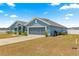 Exterior view of a single-Gathering home with attached two-car garage, garden, and beautiful blue paint at 4881 Se 91St Pl, Ocala, FL 34480
