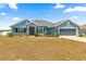 Inviting single-Gathering home with a tidy front lawn, beautiful landscaping, and an attached two-car garage at 4881 Se 91St Pl, Ocala, FL 34480