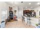 Open kitchen with tile floors, a breakfast bar with seating, and modern appliances at 4881 Se 91St Pl, Ocala, FL 34480