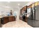 Bright kitchen with dark wood cabinets and stainless steel refrigerator; excellent storage at 4881 Se 91St Pl, Ocala, FL 34480