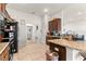 Open kitchen with granite countertops and dark wood cabinets, perfect for entertaining at 4881 Se 91St Pl, Ocala, FL 34480