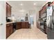 Spacious kitchen featuring stainless steel appliances, dark wood cabinetry, and tiled floors at 4881 Se 91St Pl, Ocala, FL 34480