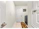 A tiled laundry room features a modern washer and dryer, and a white folding door at 4881 Se 91St Pl, Ocala, FL 34480