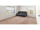 Cozy living room with plush carpeting, neutral walls, and great natural light at 4881 Se 91St Pl, Ocala, FL 34480