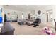 Expansive living room showcasing neutral tones, ample seating, and seamless integration with dining area at 4881 Se 91St Pl, Ocala, FL 34480