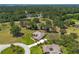 Wide angle aerial view of single story home with mature oak trees, and sprawling green yard at 5090 Nw 80Th Avenue Rd, Ocala, FL 34482