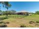 Scenic backyard with a secure fence and mature trees, offering both space and seclusion at 5090 Nw 80Th Avenue Rd, Ocala, FL 34482