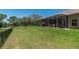 Lush backyard with a screened porch, offering a tranquil retreat and views of the surrounding landscape at 5090 Nw 80Th Avenue Rd, Ocala, FL 34482