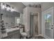 Neutral bathroom with granite countertop vanity and tiled shower, offering a blend of functionality and style at 5090 Nw 80Th Avenue Rd, Ocala, FL 34482