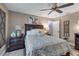 Cozy bedroom featuring a dark wood bed frame, ceiling fan, and soft rug on hardwood flooring at 5090 Nw 80Th Avenue Rd, Ocala, FL 34482