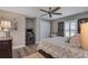 Bedroom with hardwood floors, fan, and Pac-Personal arcade cabinet bringing a fun, retro vibe to the room at 5090 Nw 80Th Avenue Rd, Ocala, FL 34482