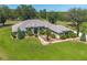 Sprawling single story home with mature trees and lush landscaping with brick accents at 5090 Nw 80Th Avenue Rd, Ocala, FL 34482