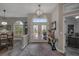 Welcoming foyer with decorative lighting, an arched transom window, and views into the adjacent dining and living areas at 5090 Nw 80Th Avenue Rd, Ocala, FL 34482