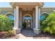 Inviting front entrance with stone pillars and lush landscaping creates a grand welcome at 5090 Nw 80Th Avenue Rd, Ocala, FL 34482