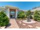 Beautiful home with a decorative water fountain and a brick walkway leading to the columned front entrance at 5090 Nw 80Th Avenue Rd, Ocala, FL 34482