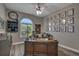 Beautiful home office featuring custom built-ins, a large wood desk, and botanical wall art at 5090 Nw 80Th Avenue Rd, Ocala, FL 34482
