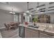 A kitchen featuring granite countertops, stainless steel appliances, and modern lighting fixtures at 5090 Nw 80Th Avenue Rd, Ocala, FL 34482