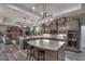 Well-lit kitchen with stainless steel appliances, custom cabinets, a large island and bar seating at 5090 Nw 80Th Avenue Rd, Ocala, FL 34482
