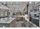 Spacious kitchen featuring stainless appliances, marble counters, and a large center island at 5090 Nw 80Th Avenue Rd, Ocala, FL 34482