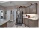 Bright kitchen with stainless steel appliances, granite countertops, and gray wood cabinets at 5090 Nw 80Th Avenue Rd, Ocala, FL 34482