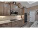 Modern kitchen features stainless steel appliances, stone countertops, and custom cabinetry at 5090 Nw 80Th Avenue Rd, Ocala, FL 34482