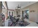 Covered patio with ceiling fan and wicker furniture, creating a comfortable spot for outdoor gatherings at 5090 Nw 80Th Avenue Rd, Ocala, FL 34482
