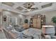 A spacious living room featuring a decorative ceiling, stylish furniture, and an entertainment center at 5090 Nw 80Th Avenue Rd, Ocala, FL 34482
