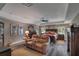 The spacious main bedroom features a tray ceiling, a ceiling fan, and a comfortable seating area at 5090 Nw 80Th Avenue Rd, Ocala, FL 34482
