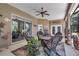 Inviting covered patio with wicker furniture, ceiling fan, and tasteful decor perfect for outdoor relaxation at 5090 Nw 80Th Avenue Rd, Ocala, FL 34482