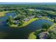 An aerial view reveals a community with mature trees and lake, providing a tranquil setting for the condos and its residents at 515 Midway Dr # A, Ocala, FL 34472