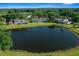 Scenic aerial view featuring well-maintained condos, lake, and lush landscaping, creating a tranquil community setting at 515 Midway Dr # A, Ocala, FL 34472