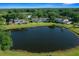 Picturesque aerial view highlighting homes surrounding a serene lake amidst lush greenery and trees at 515 Midway Dr # A, Ocala, FL 34472