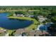 Scenic aerial shot showcasing houses by the lake surrounded by a lush landscape with trees and vegetation at 515 Midway Dr # A, Ocala, FL 34472