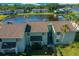 Overhead view of condos showcasing lake frontage, lush landscaping, and well-maintained community at 515 Midway Dr # A, Ocala, FL 34472