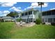 Expansive backyard featuring lush green grass, a brick patio with seating, and a view of the building at 515 Midway Dr # A, Ocala, FL 34472