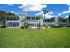 Wide backyard with a brick patio featuring seating and umbrellas, set against a backdrop of lush greenery and building at 515 Midway Dr # A, Ocala, FL 34472
