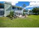 Inviting backyard with a brick patio, outdoor seating, lush greenery, and a view of the building at 515 Midway Dr # A, Ocala, FL 34472