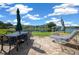 Picturesque backyard patio with a dining table and lounge chair overlooking a scenic lake and lush greenery at 515 Midway Dr # A, Ocala, FL 34472