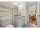 Bright bathroom with granite vanity, white cabinets, and a view into the bedroom at 515 Midway Dr # A, Ocala, FL 34472