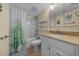 Well-lit bathroom featuring a shower/tub combination, granite vanity, and decorative plants at 515 Midway Dr # A, Ocala, FL 34472