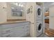 Bathroom featuring a granite vanity, white cabinets, and a stacked washer and dryer at 515 Midway Dr # A, Ocala, FL 34472