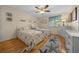 Inviting bedroom with two twin beds, a ceiling fan, and beach-themed decor at 515 Midway Dr # A, Ocala, FL 34472