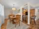 Inviting dining area featuring a chandelier, wood table with seating, and a view into the kitchen and bar at 515 Midway Dr # A, Ocala, FL 34472