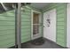 Condominium entrance featuring screen door, decorative door accents, and welcome mat at 515 Midway Dr # A, Ocala, FL 34472