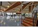 Large event space featuring a stage, wood beamed ceiling, and expansive windows at 515 Midway Dr # A, Ocala, FL 34472