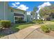 Inviting condominium with lush landscaping along the sidewalk, and clear blue skies at 515 Midway Dr # A, Ocala, FL 34472