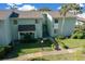 Charming two-story condo with lush landscaping, well-maintained lawn, and inviting entryway at 515 Midway Dr # A, Ocala, FL 34472