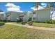 Charming two-story condominium exterior featuring lush lawn and landscaping under a sunny sky at 515 Midway Dr # A, Ocala, FL 34472